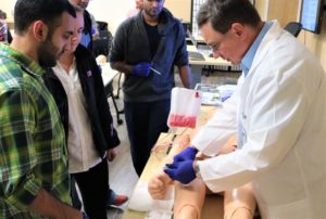 Dr. Podcheko instructing students in one of the AUIS simulation labs.